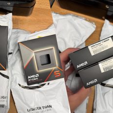 Two boxes of AMD Ryzen 5 9600X processors with '9000 Series Processor' packaging are placed on opened plastic mailer bags.
