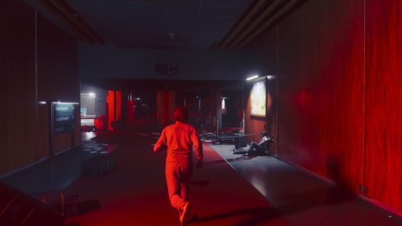 A character in an orange jumpsuit labeled 'P6' runs down a dimly lit corridor in the game 'Control Resonant' with directional signs reading 'Central Executive', 'Executive Research', and 'P6 Holding'.