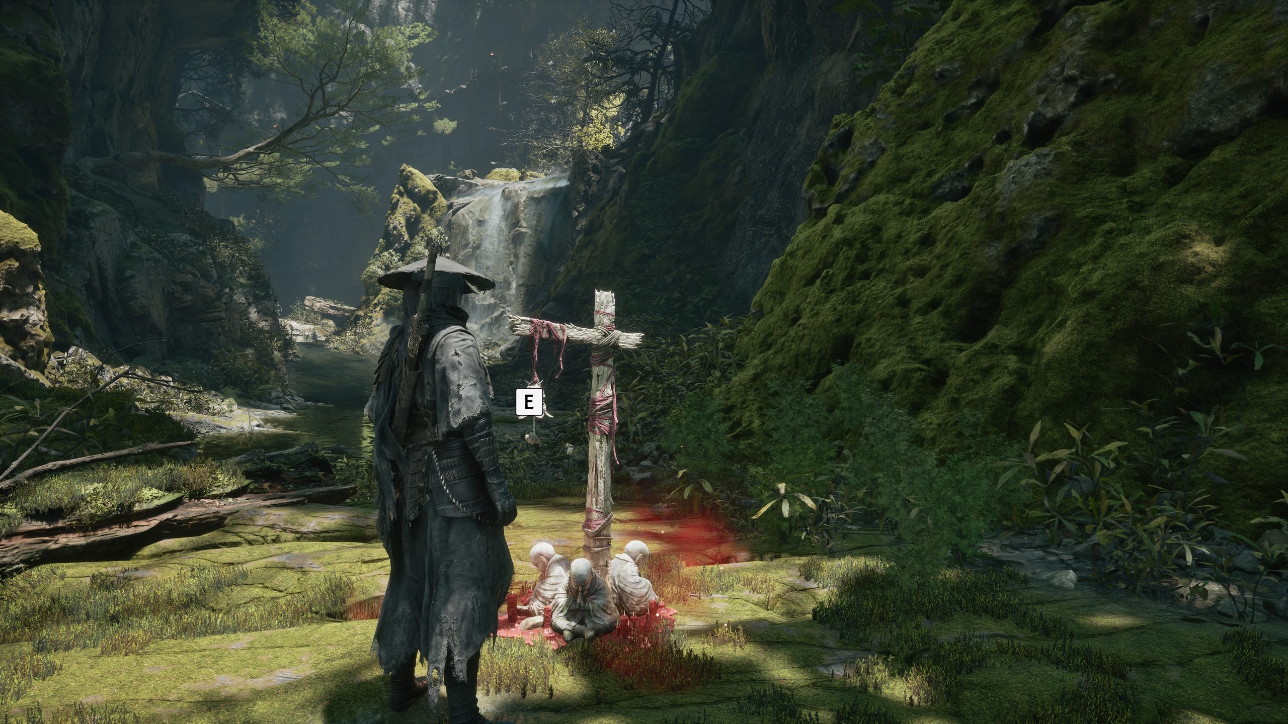 A figure in a dark cloak stands near a cross adorned with strips of fabric and surrounded by seated, mummified figures emitting a red aura, with a prompt reading 