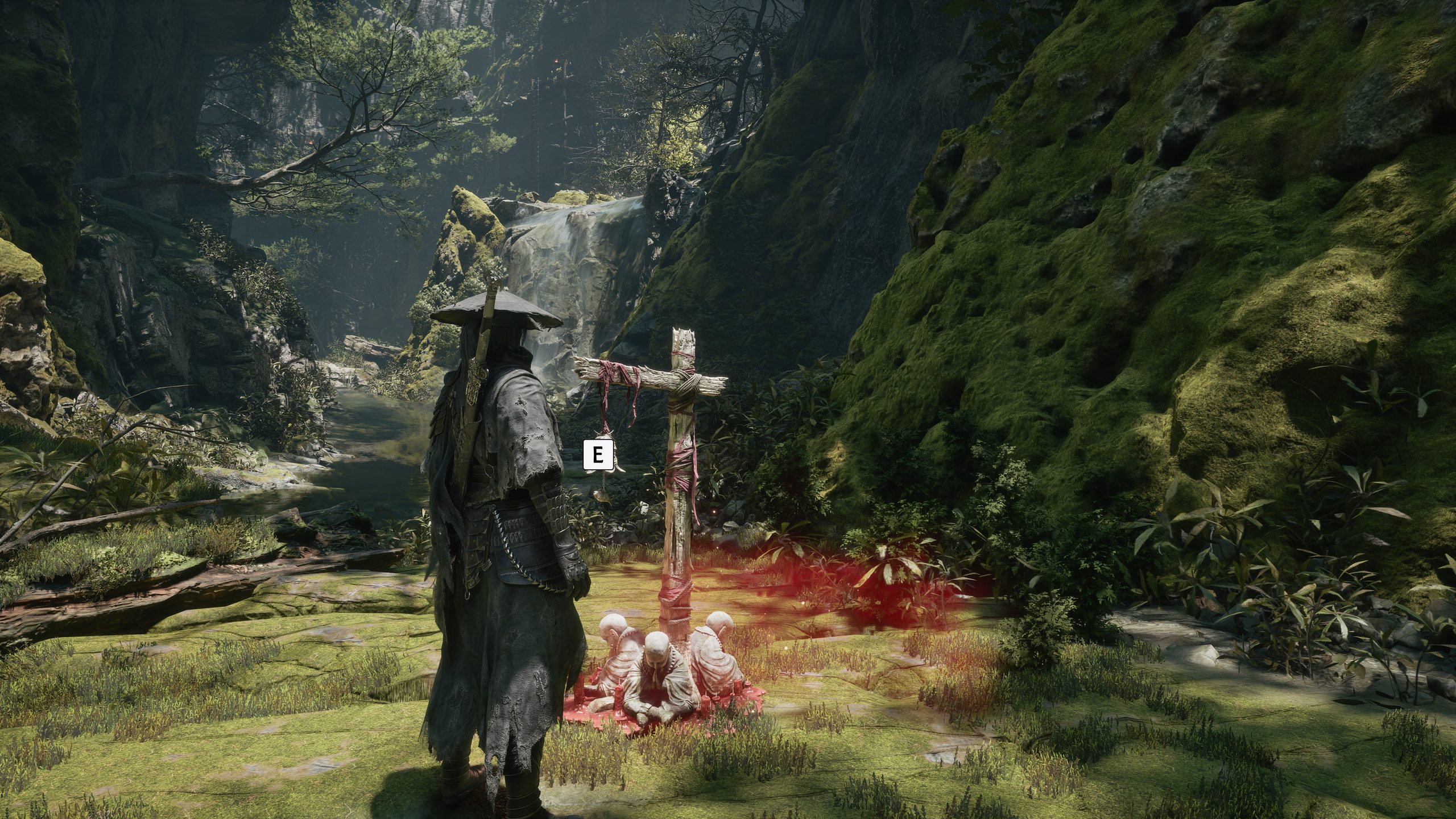A robed figure stands in a lush forest near a wooden pole surrounded by small statues in 