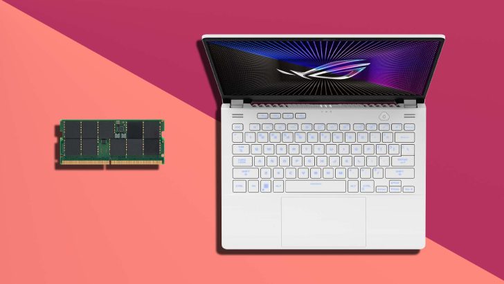 An ASUS ROG laptop with an illuminated keyboard is placed beside a RAM stick on a two-tone background.