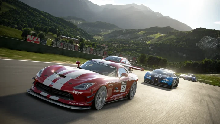 Cars race on a scenic track in the video game 'Gran Turismo,' featuring a Dodge Viper in the foreground.