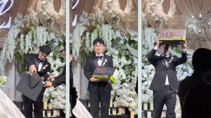 A person in a suit holding a GPU box labeled 'MSI GeForce RTX 5090' during an event with floral decorations.