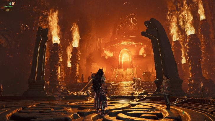 A character in the game Lords of the Fallen stands before a fiery temple entrance amidst towering flames.