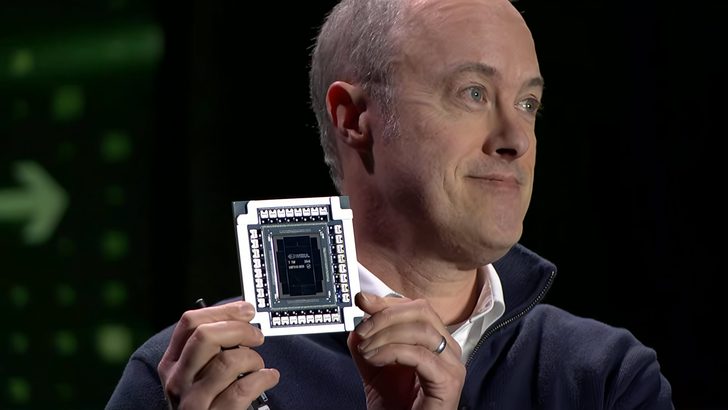 A person holding an NVIDIA chip labeled 'GH100'.