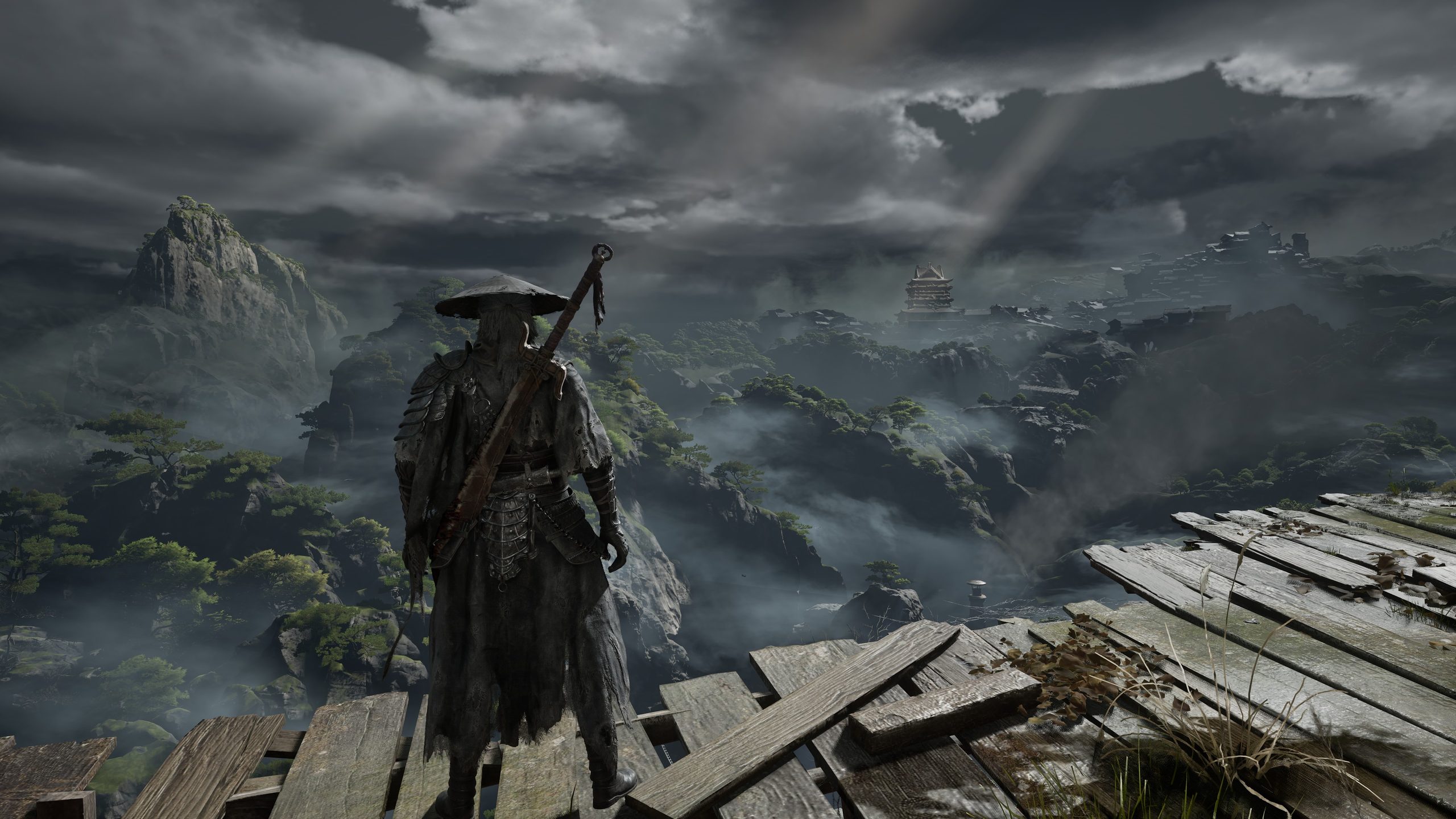 A character in 'Black Myth: Wukong' stands on a wooden platform, overlooking a misty, mountainous landscape.