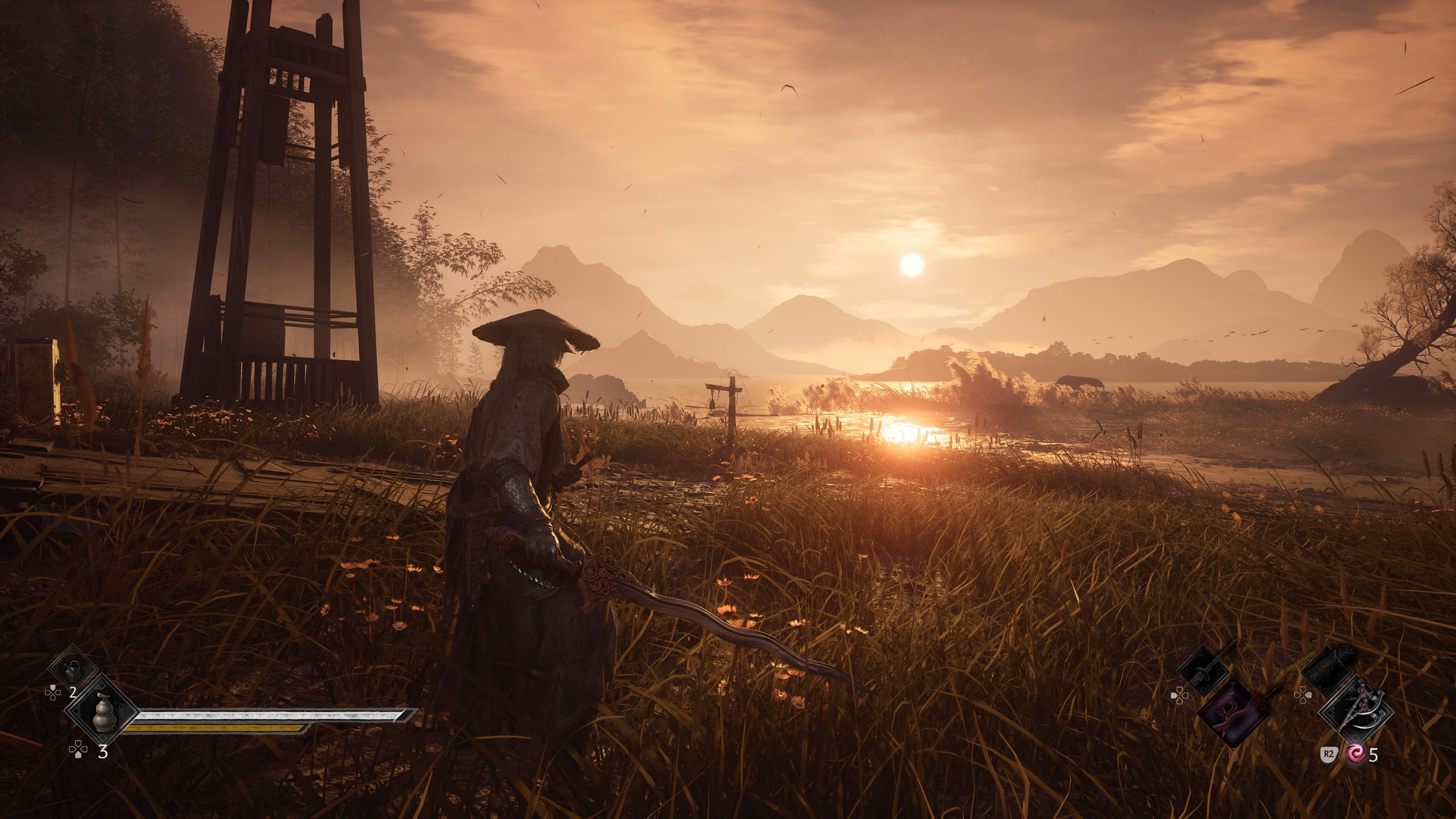 A character in Wo Long: Fallen Dynasty stands in a grassy landscape at sunset, with an interface showing weapons and health.