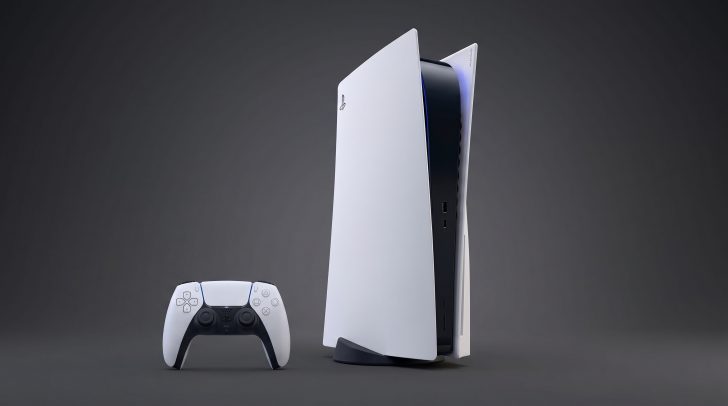 A Sony PlayStation 5 console standing vertically next to a DualSense wireless controller on a dark background.