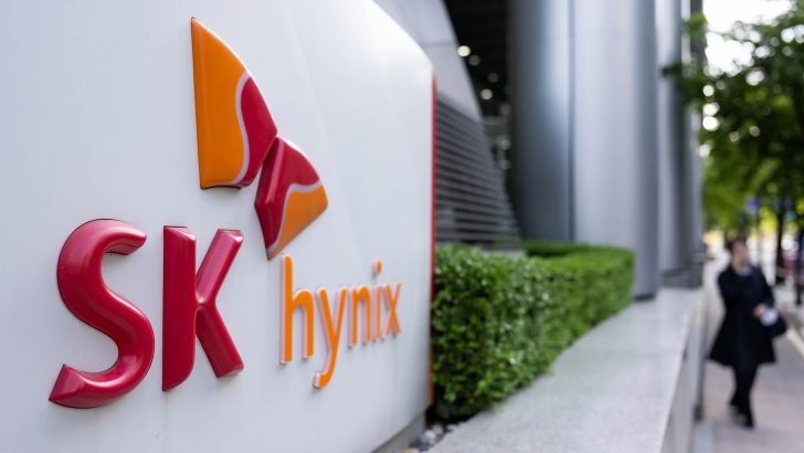 The SK Hynix logo is prominently displayed on a building with a blurred pedestrian passing by.