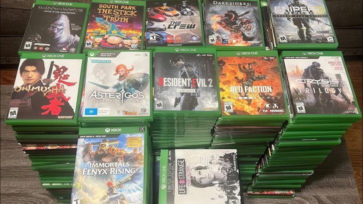 A collection of Xbox game cases featuring titles like Shadow of Mordor, South Park: The Stick of Truth, The Crew, Darksiders, Resident Evil 2 Deluxe Edition, and Crysis Remastered Trilogy.